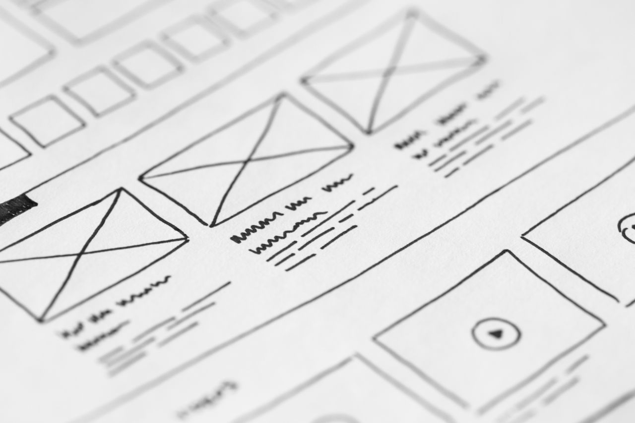 about-03 Detailed close-up of a hand-drawn wireframe design on paper for a UX project.